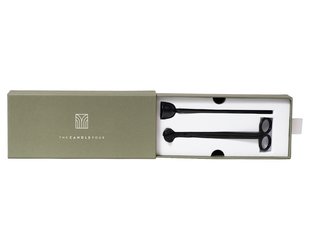 A accessory box that slides open to show off a wick trimmer and snuffer.